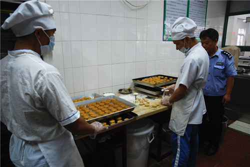 图为老王正在为戒毒所学员们制作月饼，他将为学员们准备四种样式、五种口味的月饼共一千多个
